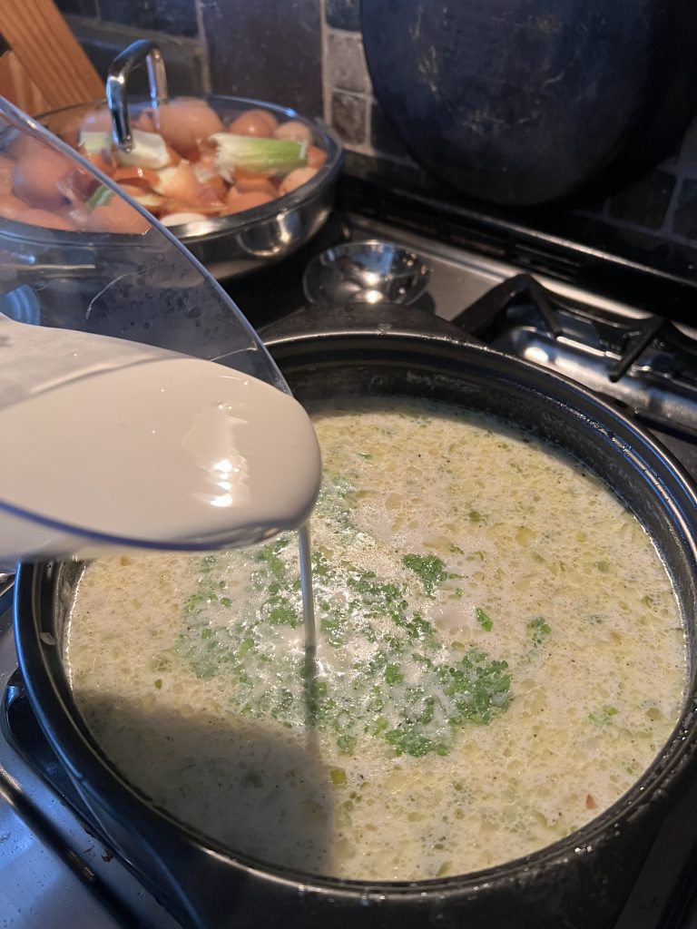 Here I'm adding the heavy cream. you can see my chicken food scraps in the backround